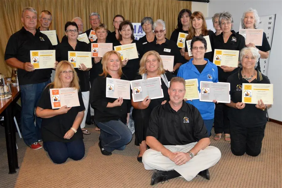 Pet sitters holding up their certificates